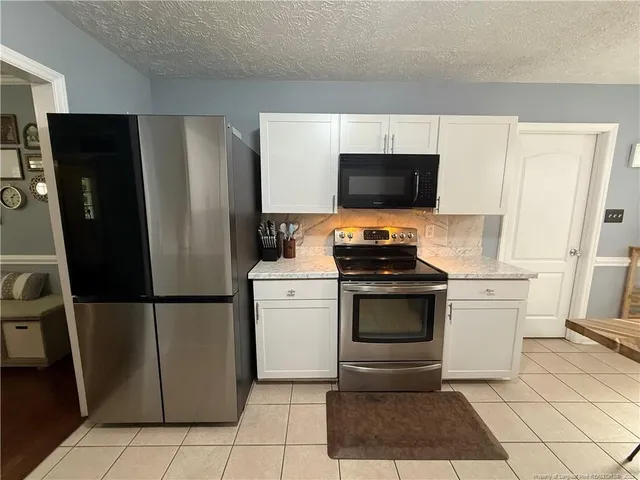 a kitchen with a refrigerator and a stove