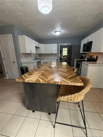 a view of kitchen with cabinets