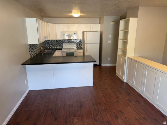 1563 South 600 East Springville, UT 84663 - Photo 11 of 30 Kitchen with white cabinetry, dark countertops, and a mosaic tile backsplash