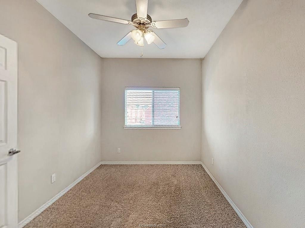 1198 Jones-Butler Road, Unit 2607 College Station, TX 77840 - Photo 22 of 26 an empty room with a window and a ceiling fan