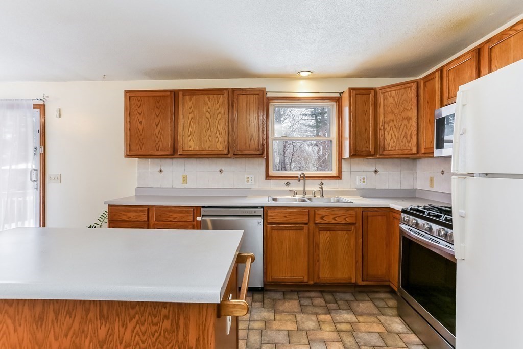 52 Eleanor Road Springfield, MA 01108 - Photo 12 of 34 a kitchen with a sink stove and cabinets