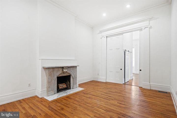 306 South 10th Street, Unit A Philadelphia, PA 19107 - Photo 2 of 36 a view of empty room with wooden floor and fireplace