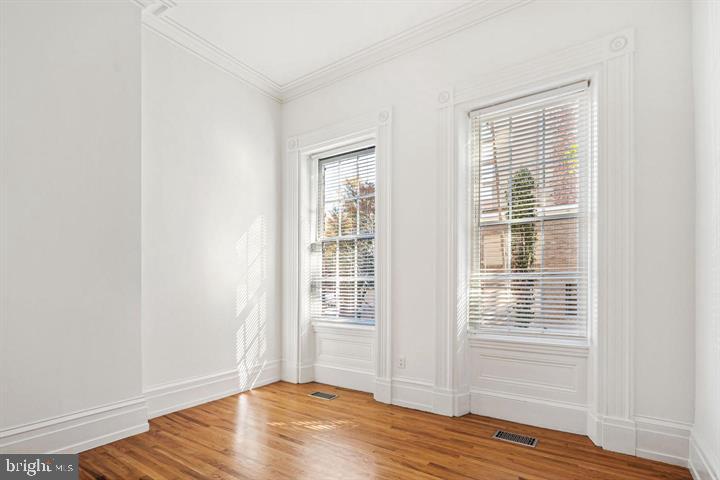 306 South 10th Street, Unit A Philadelphia, PA 19107 - Photo 21 of 36 a view of an empty room with wooden floor and a window