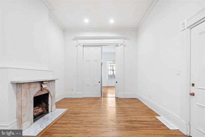 306 South 10th Street, Unit A Philadelphia, PA 19107 - Photo 3 of 36 a view of empty room with wooden floor and fireplace