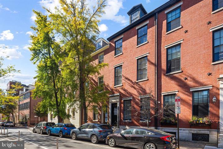 306 South 10th Street, Unit A Philadelphia, PA 19107 - Photo 34 of 36 a city street lined with parked cars and buildings