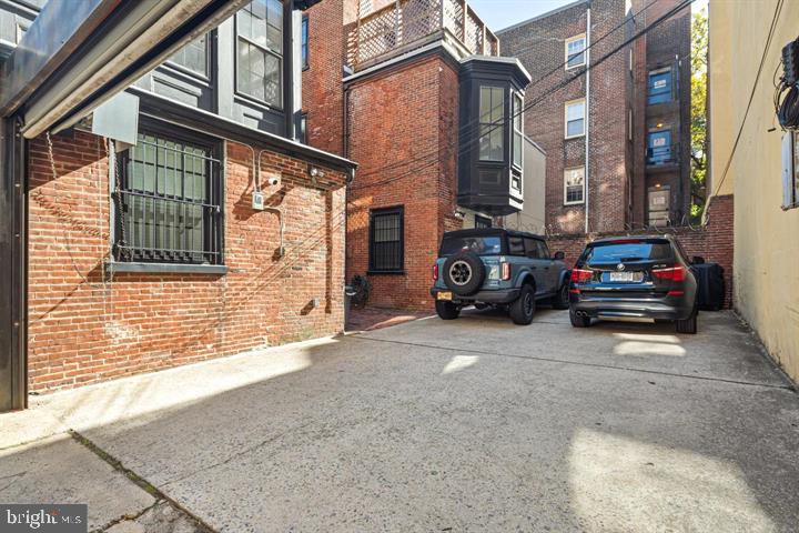 306 South 10th Street, Unit A Philadelphia, PA 19107 - Photo 8 of 36 a view of a car park in front of a brick building