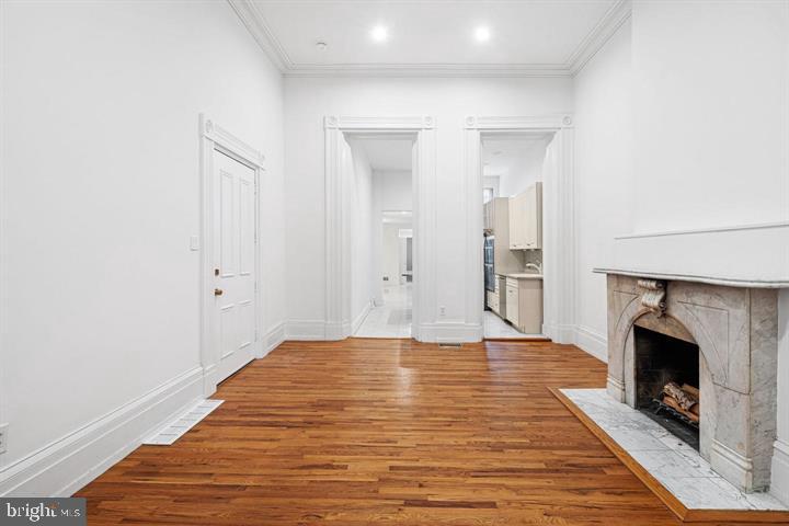 306 South 10th Street, Unit A Philadelphia, PA 19107 - Photo 9 of 36 a view of empty room with wooden floor and fireplace