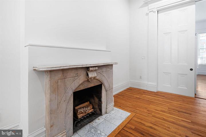 306 South 10th Street, Unit A Philadelphia, PA 19107 - Photo 10 of 36 a bedroom with a bed and a fireplace