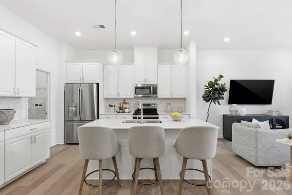 a view of kitchen with refrigerator dining table and chairs