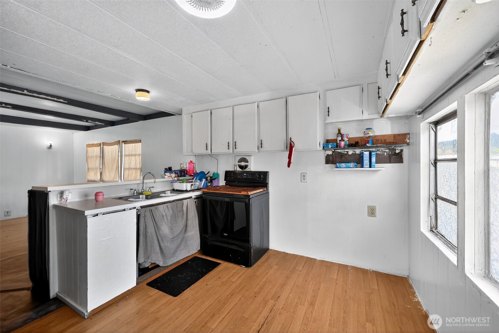 66 Fairgrounds Road, Unit 21 Elma, WA 98541 - Photo 21 of 31 a kitchen with stainless steel appliances granite countertop a refrigerator a sink dishwasher a stove and white countertops with wooden floor
