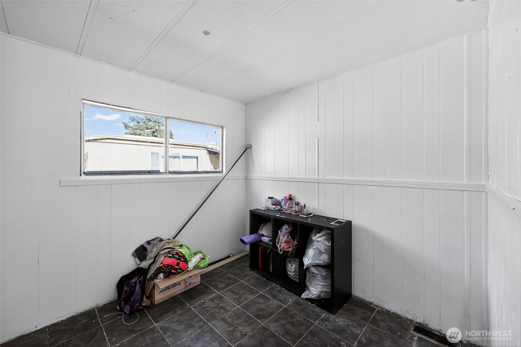 66 Fairgrounds Road, Unit 21 Elma, WA 98541 - Photo 27 of 31 a living room with a baby crib furniture and a window