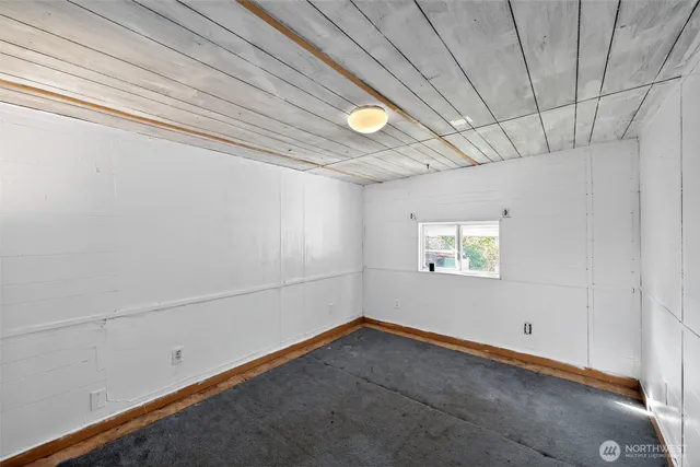 a view of a room with window and ceiling fan