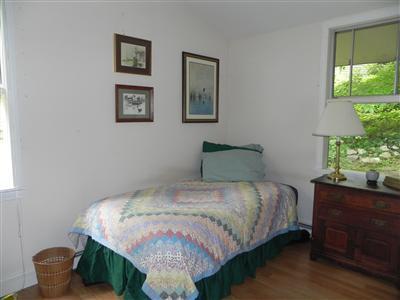 16 F R Lillie Road Woods Hole, MA 02543 - Photo 9 of 19 a bedroom with a bed and a potted plant