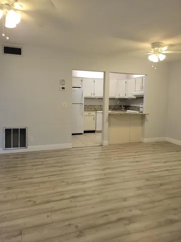 a view of kitchen and empty room