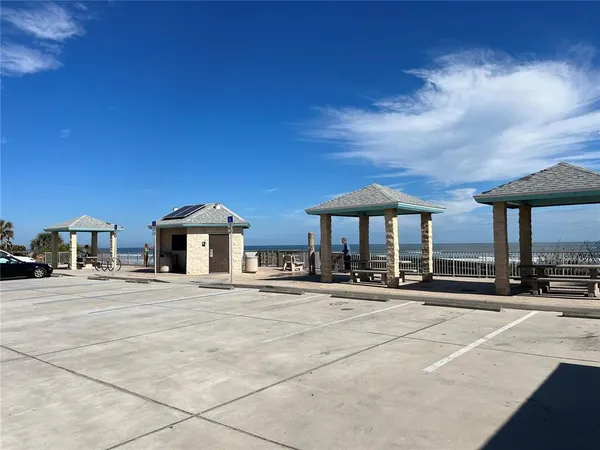a patio with a table and chairs under an umbrella