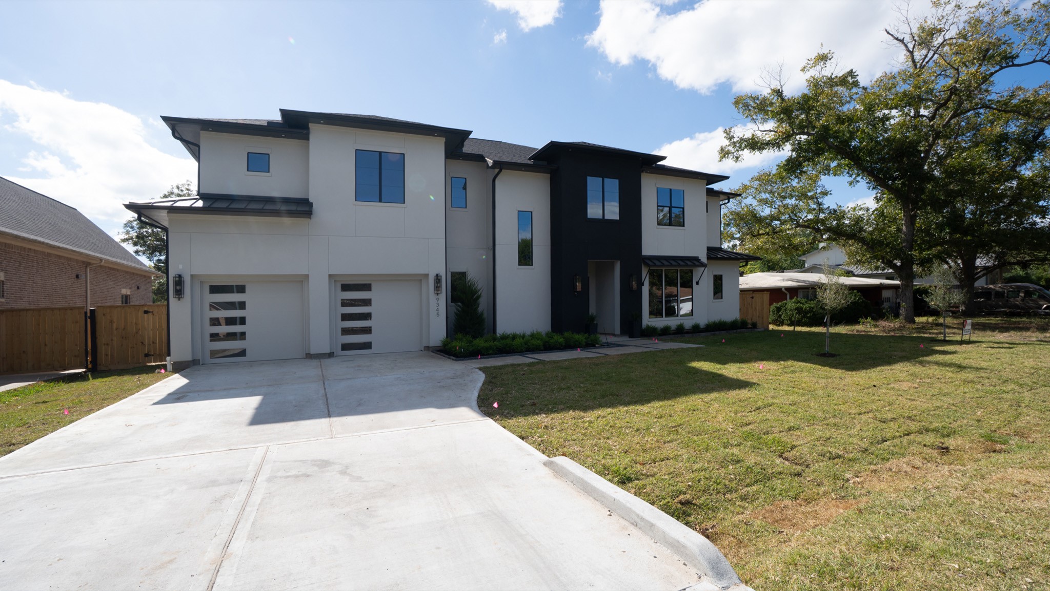 9345 Leto Road Houston, TX 77080 - Photo 20 of 22 a front view of a house with a yard and garage
