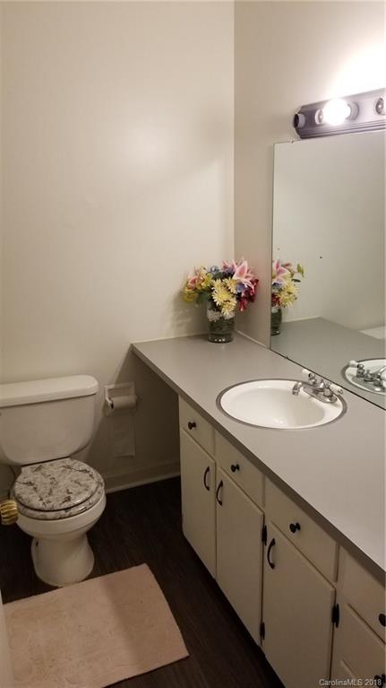 7045 Ridge Lane Road Charlotte, NC 28262 - Photo 12 of 19 a bathroom with a granite countertop sink a toilet and a mirror