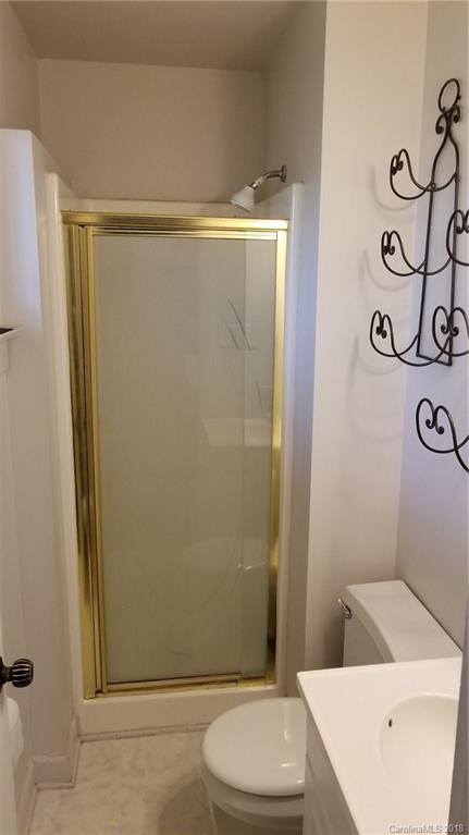 7045 Ridge Lane Road Charlotte, NC 28262 - Photo 19 of 19 a bathroom with a shower and a toilet