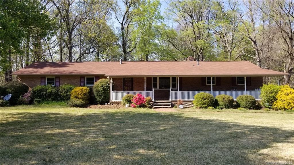 7045 Ridge Lane Road Charlotte, NC 28262 - Photo 3 of 19 a front view of a house with a yard table and chairs