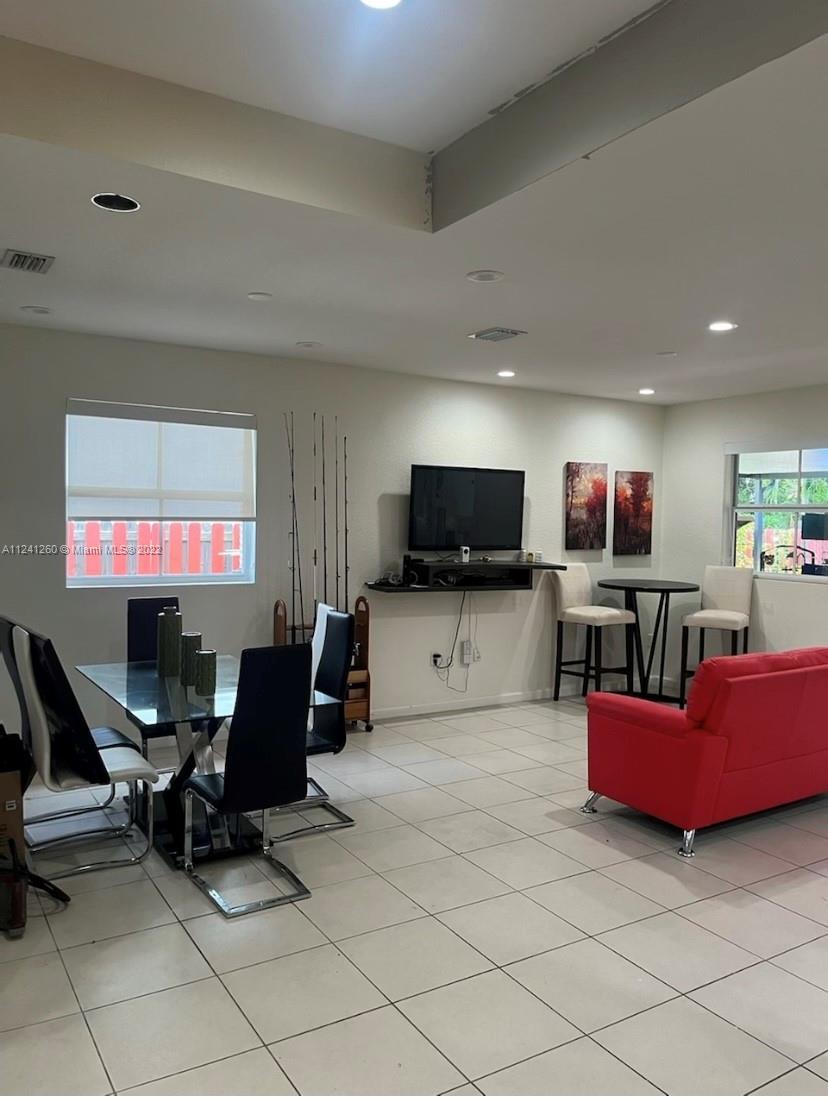 28281 Southwest 128th Place Homestead, FL 33033 - Photo 11 of 39 a living room with furniture and a flat screen tv