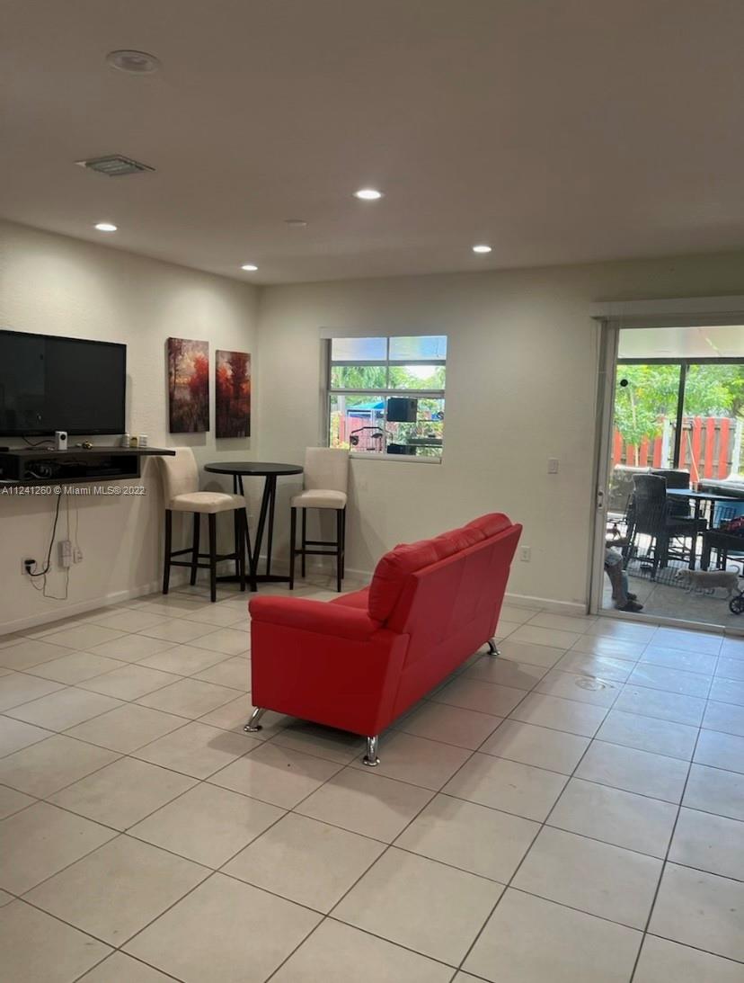 28281 Southwest 128th Place Homestead, FL 33033 - Photo 12 of 39 a living room with furniture and a flat screen tv