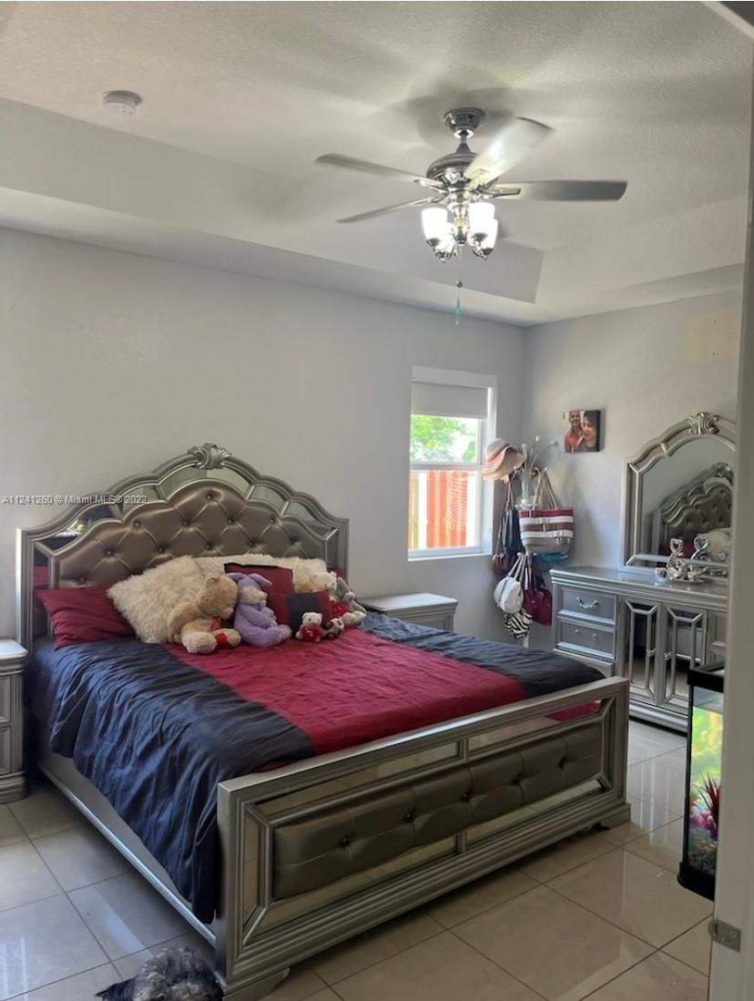 28281 Southwest 128th Place Homestead, FL 33033 - Photo 15 of 39 a bedroom with a bed and window