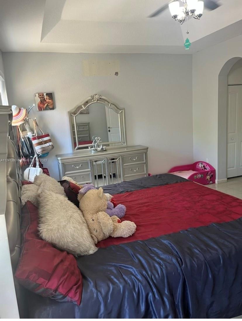 28281 Southwest 128th Place Homestead, FL 33033 - Photo 16 of 39 a bedroom with a bed and window