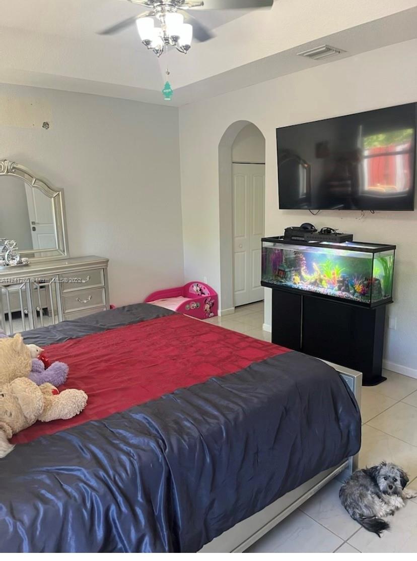 28281 Southwest 128th Place Homestead, FL 33033 - Photo 17 of 39 a bedroom with a bed and a flat screen tv