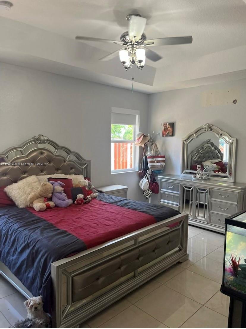 28281 Southwest 128th Place Homestead, FL 33033 - Photo 18 of 39 a bedroom with bed and window