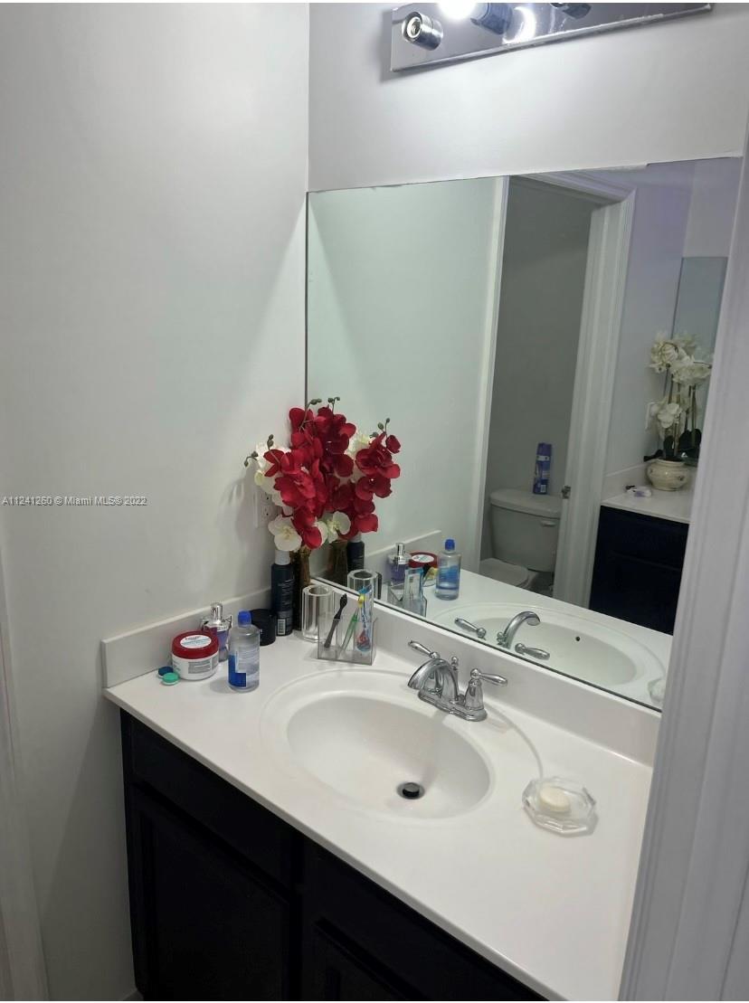 28281 Southwest 128th Place Homestead, FL 33033 - Photo 20 of 39 a bathroom with a sink and a mirror