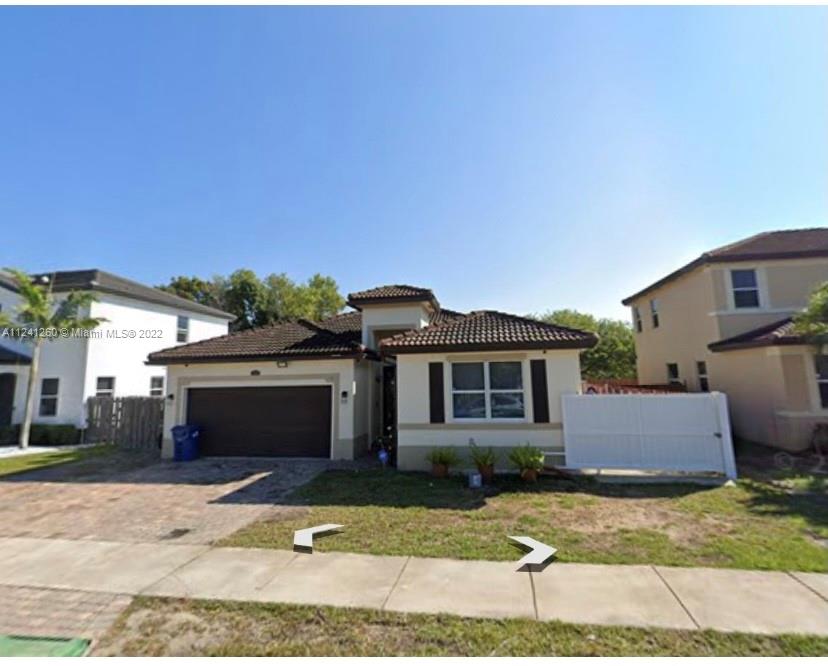 28281 Southwest 128th Place Homestead, FL 33033 - Photo 2 of 39 a front view of a house with a yard