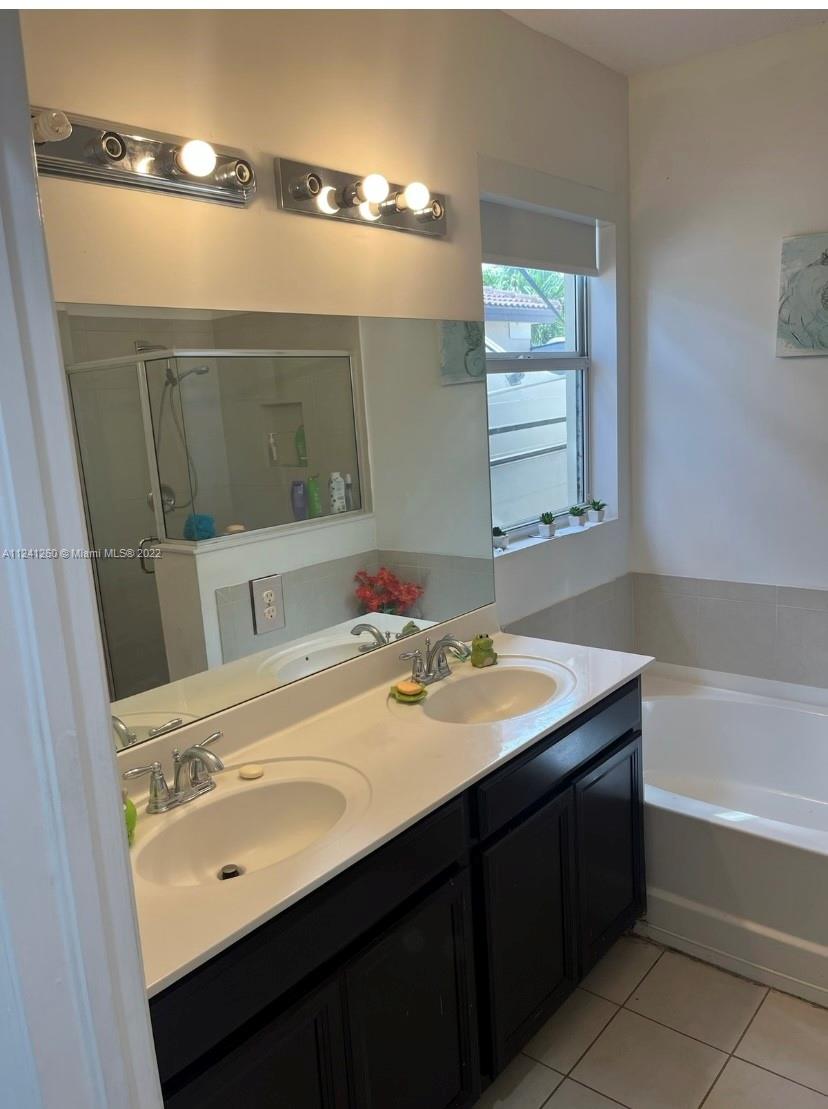 28281 Southwest 128th Place Homestead, FL 33033 - Photo 25 of 39 a bathroom with a sink and a mirror
