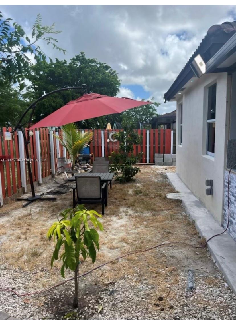 28281 Southwest 128th Place Homestead, FL 33033 - Photo 30 of 39 a view of a backyard with a patio