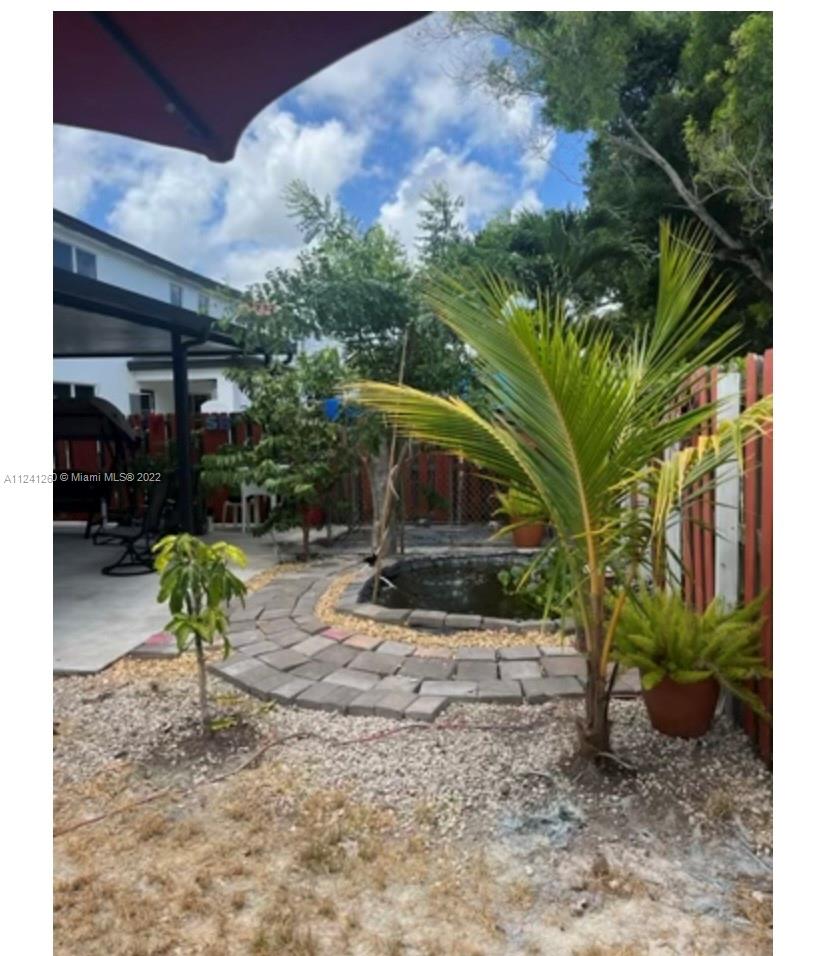 28281 Southwest 128th Place Homestead, FL 33033 - Photo 31 of 39 a view of a chairs and table in backyard