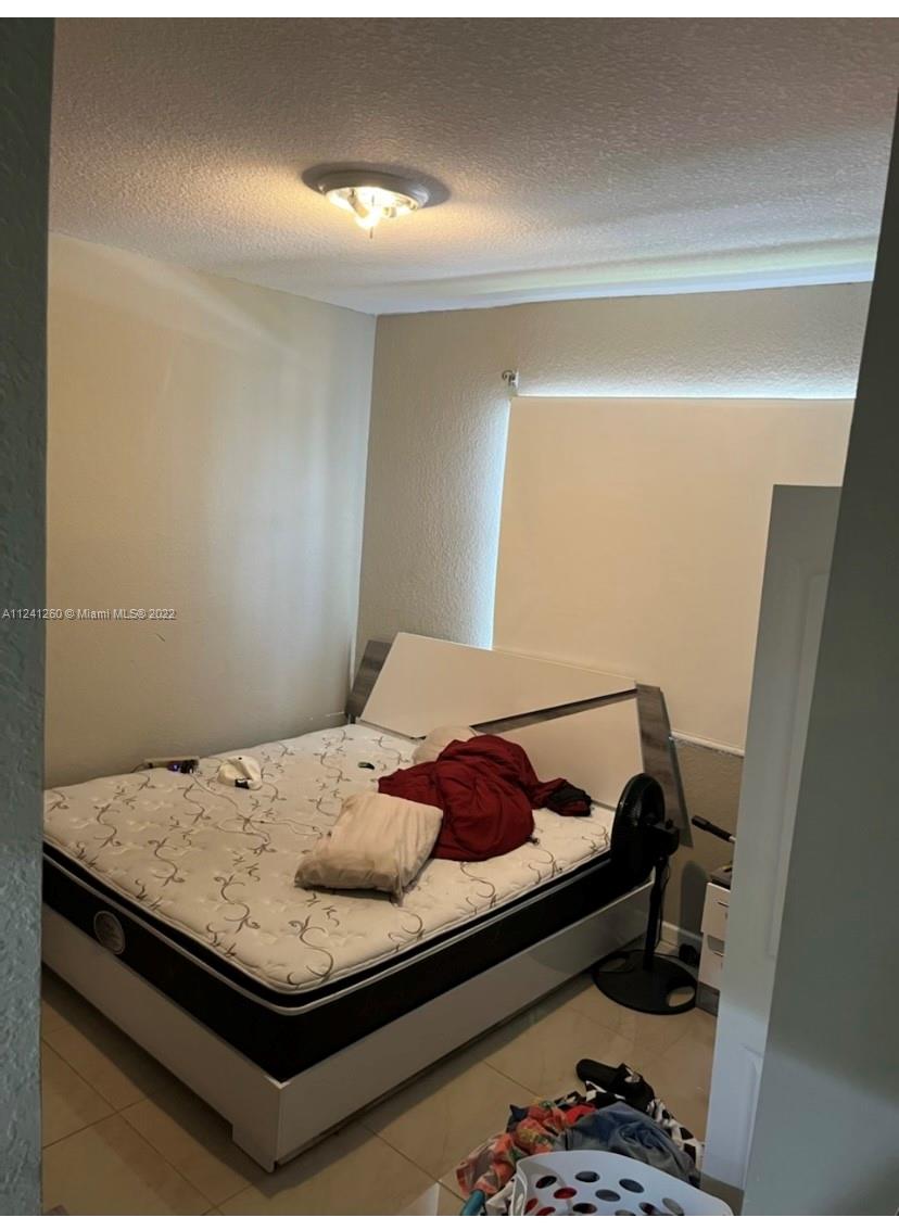 28281 Southwest 128th Place Homestead, FL 33033 - Photo 39 of 39 a bedroom with a bed and dresser
