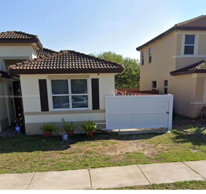 28281 Southwest 128th Place Homestead, FL 33033 - Photo 4 of 39 a front view of a house with a garden