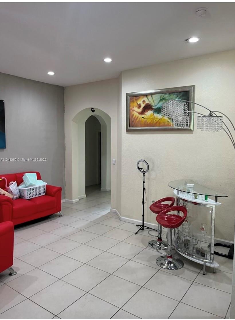 28281 Southwest 128th Place Homestead, FL 33033 - Photo 5 of 39 a living room with furniture and a table