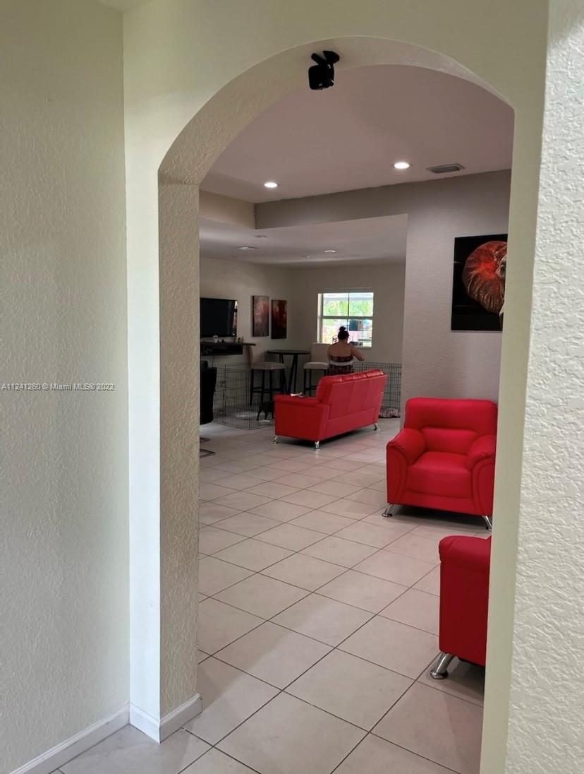 28281 Southwest 128th Place Homestead, FL 33033 - Photo 6 of 39 a living room with furniture and a flat screen tv