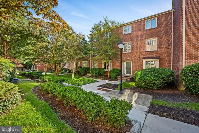 a view of a brick building next to a yard