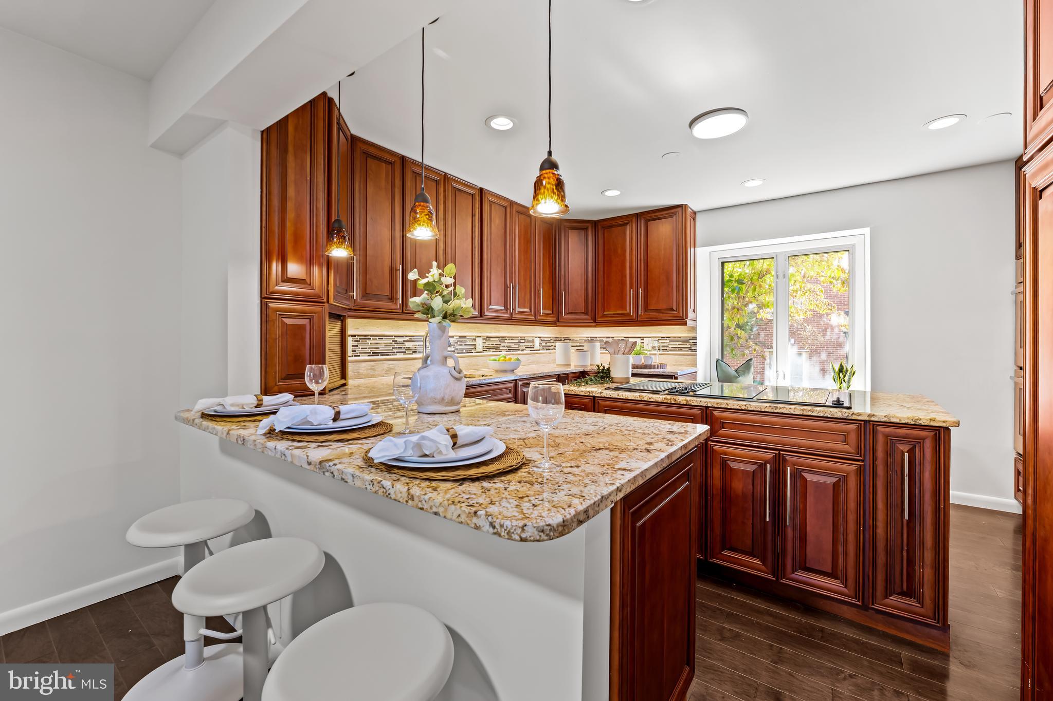 254 Waxter Way Baltimore, MD 21217 - Photo 10 of 44 a kitchen with stainless steel appliances granite countertop a sink a window and chairs