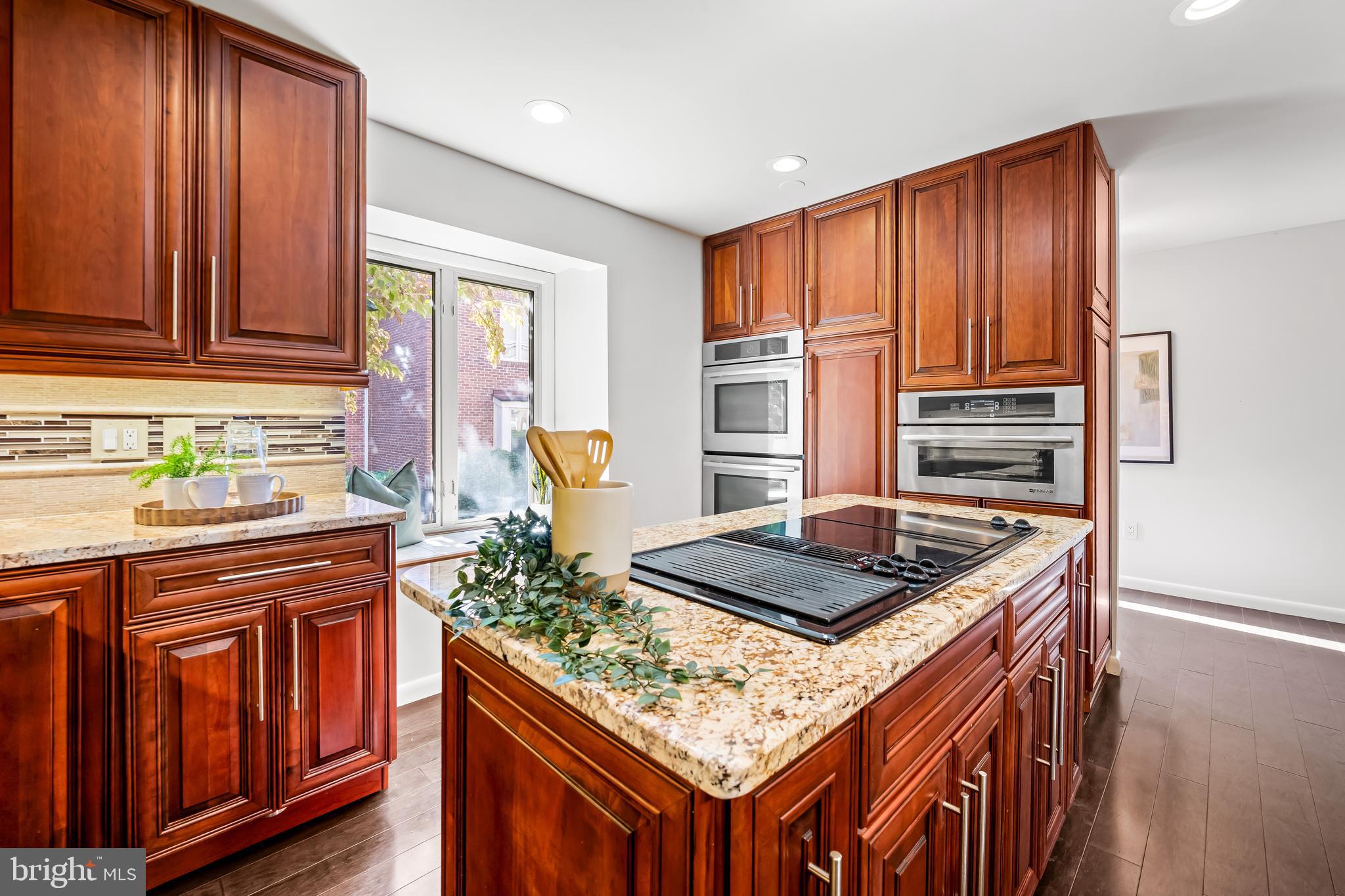 254 Waxter Way Baltimore, MD 21217 - Photo 12 of 44 a kitchen with stainless steel appliances granite countertop wooden cabinets a stove and a window