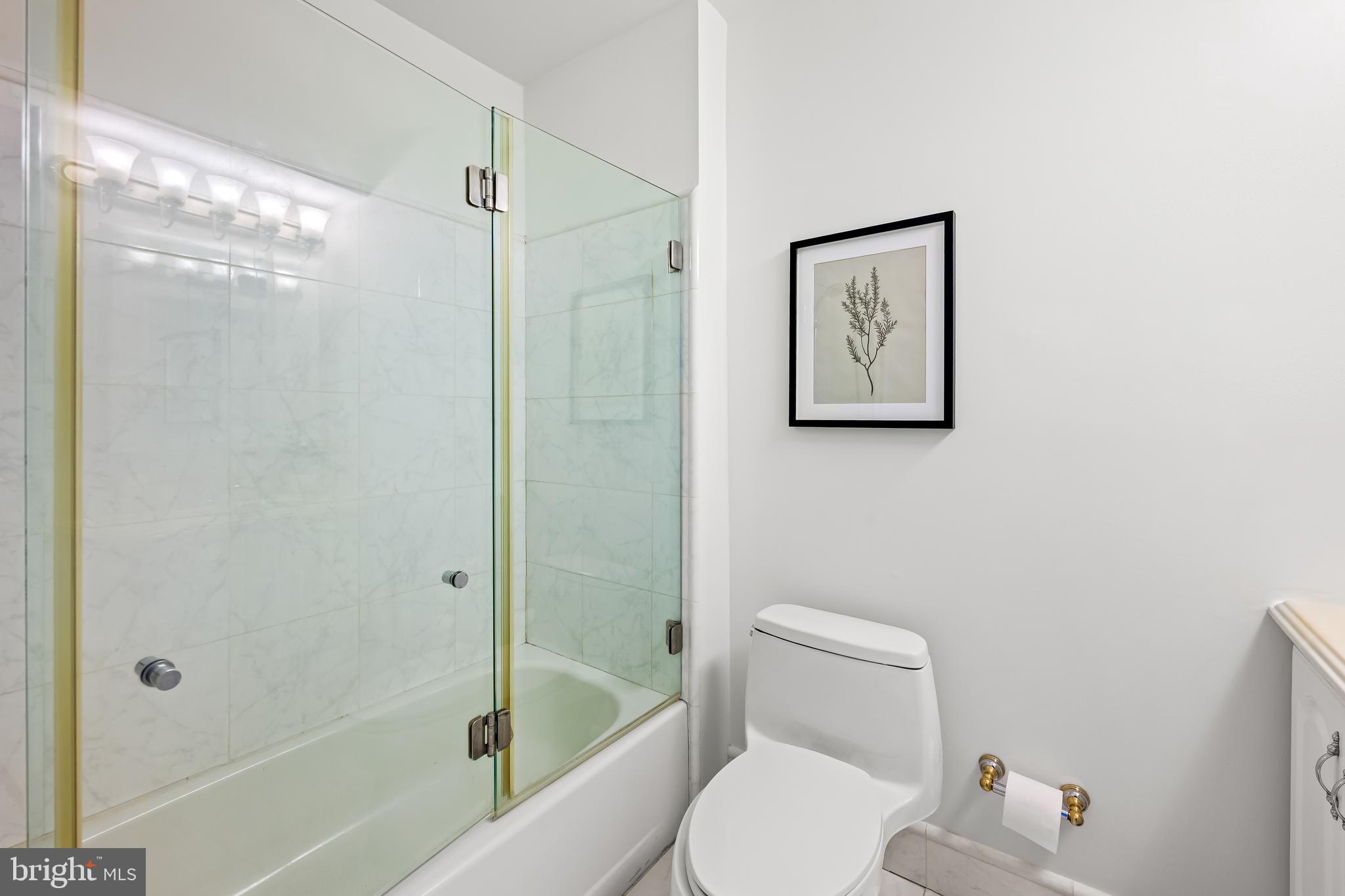 254 Waxter Way Baltimore, MD 21217 - Photo 24 of 44 a white toilet sitting next to a bath tub shower