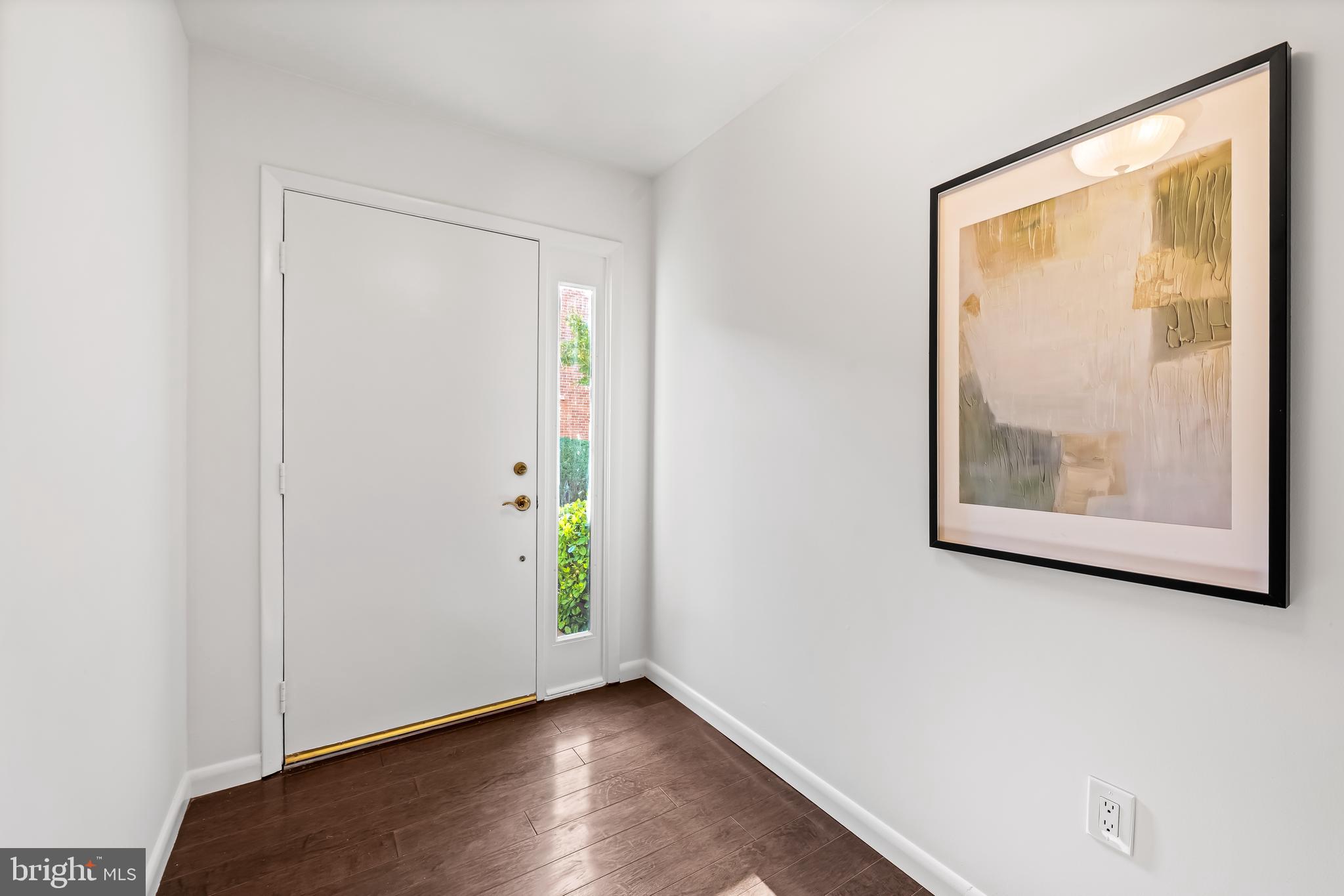 254 Waxter Way Baltimore, MD 21217 - Photo 4 of 44 a view of an empty room with wooden floor and a window