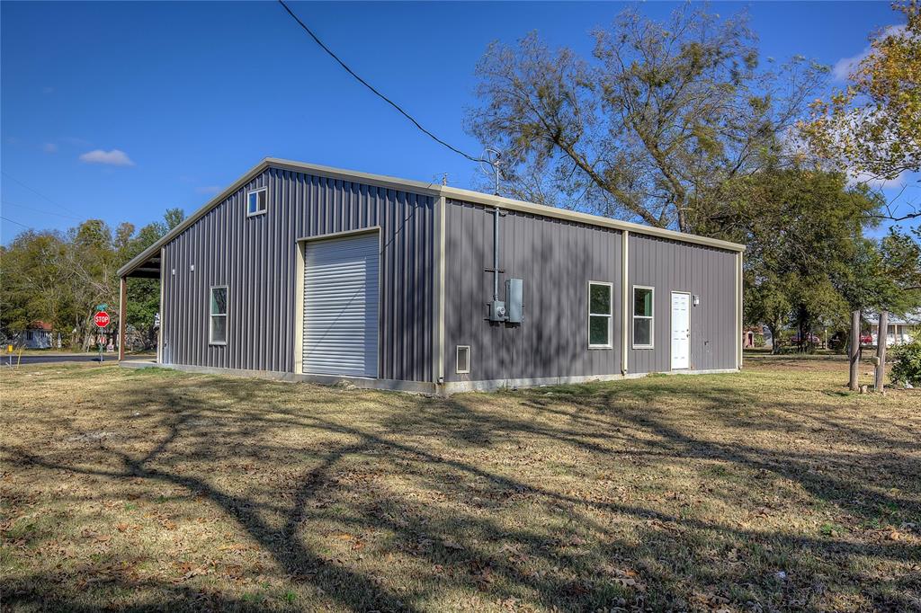 520 North 1st Street Point, TX 75472 - Photo 32 of 34 a front view of a house with a yard and garage