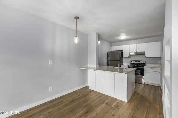 a kitchen with stainless steel appliances a refrigerator and a stove top oven