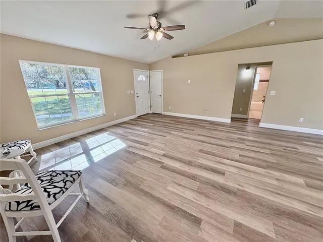 a kitchen with stainless steel appliances kitchen island granite countertop a stove refrigerator and microwave