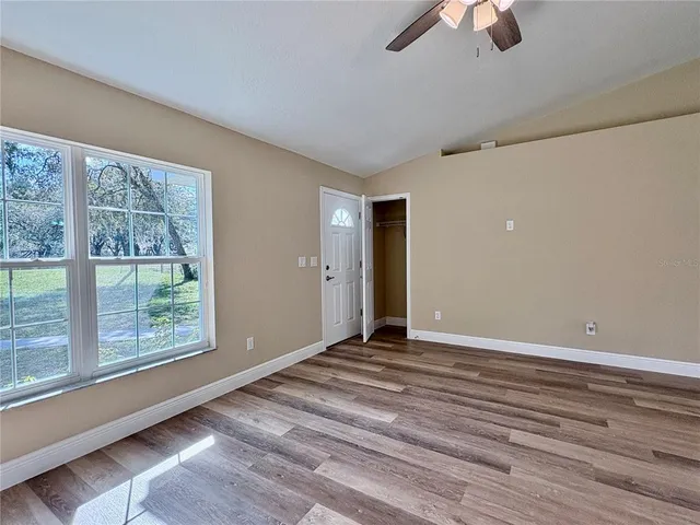 a bathroom with a granite countertop sink a mirror and a shower