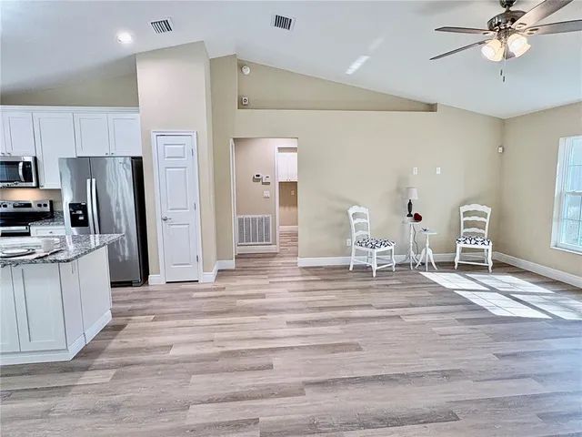 a bathroom with a granite countertop sink a toilet and shower