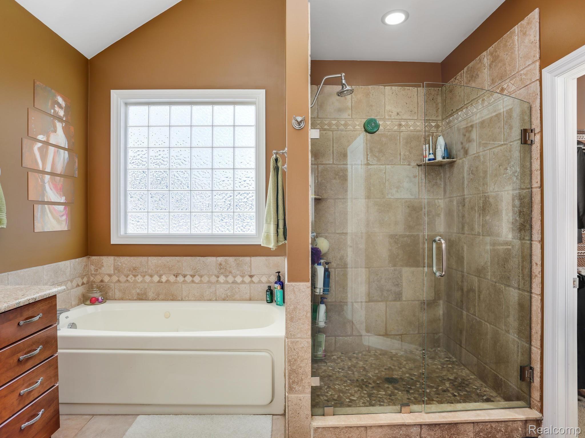 1067 Marsh Ridge Brighton, MI 48114 - Photo 21 of 39 Premium deep soak Jacuzzi tub and custom stonework shower in the master bath.