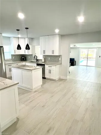 a kitchen with a sink stove and refrigerator
